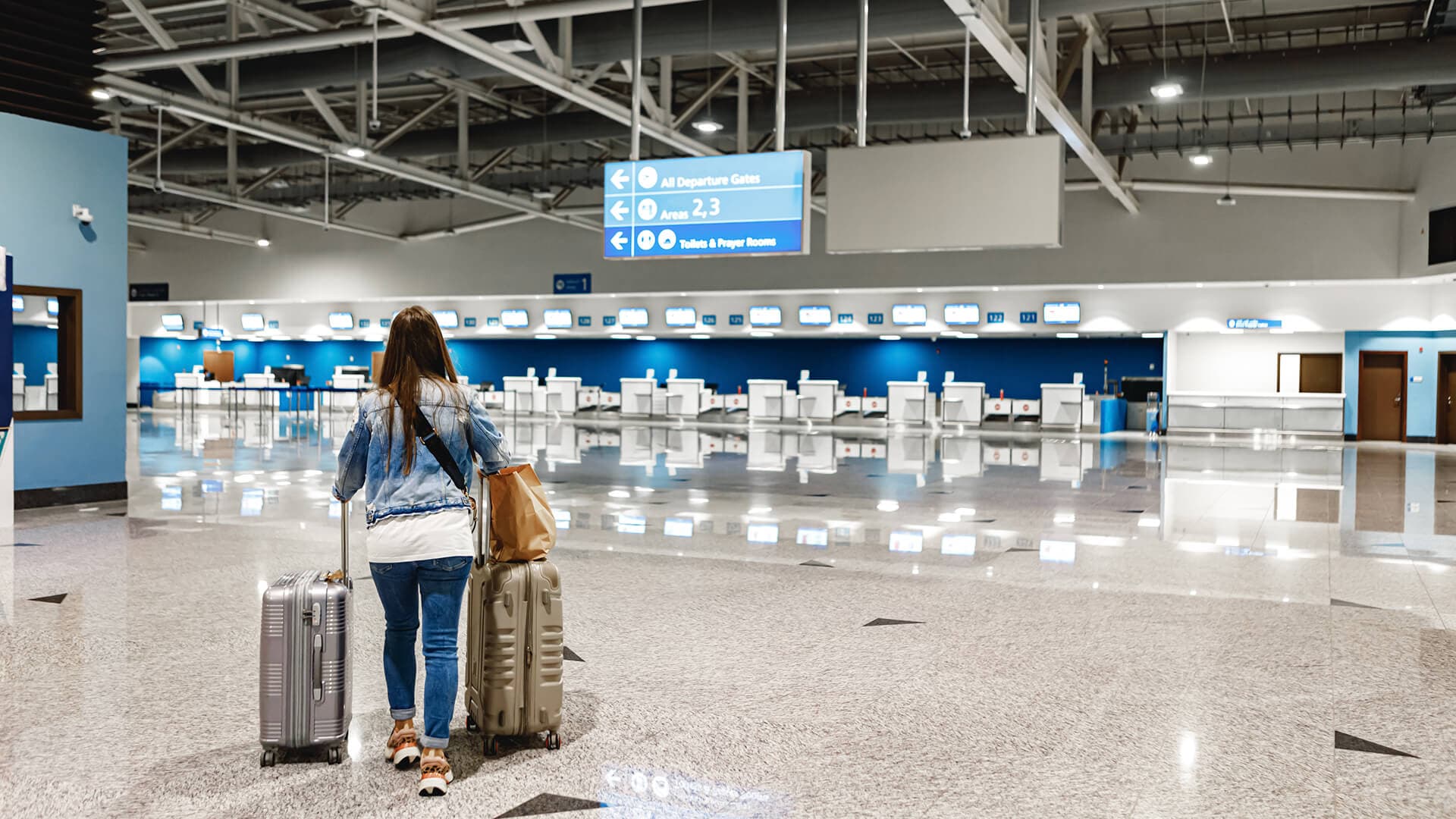Traveller with luggage at airport check-in
